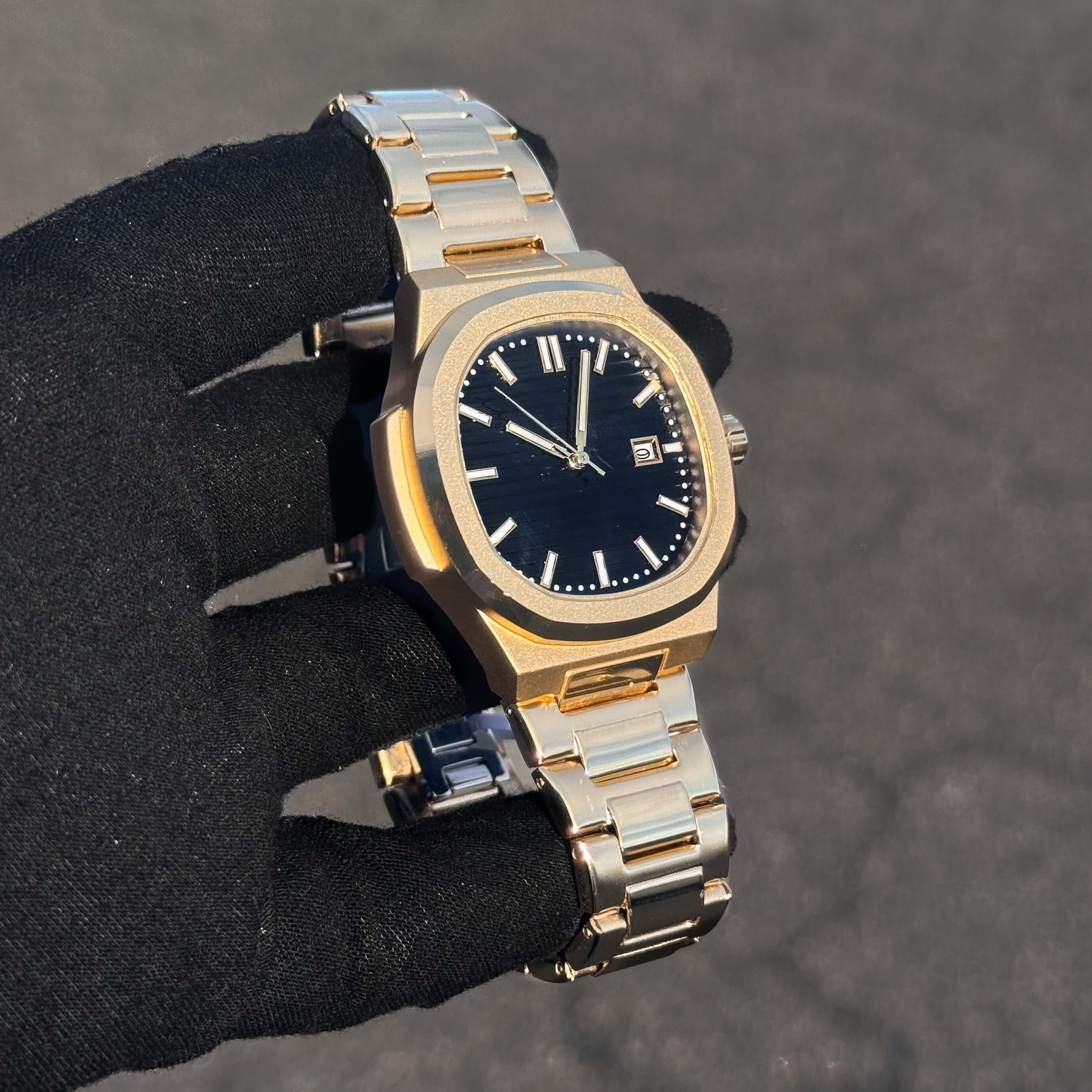 Men’s 42mm Classic Oblong Dial Watch angled view with black textured dial and gold finish case.