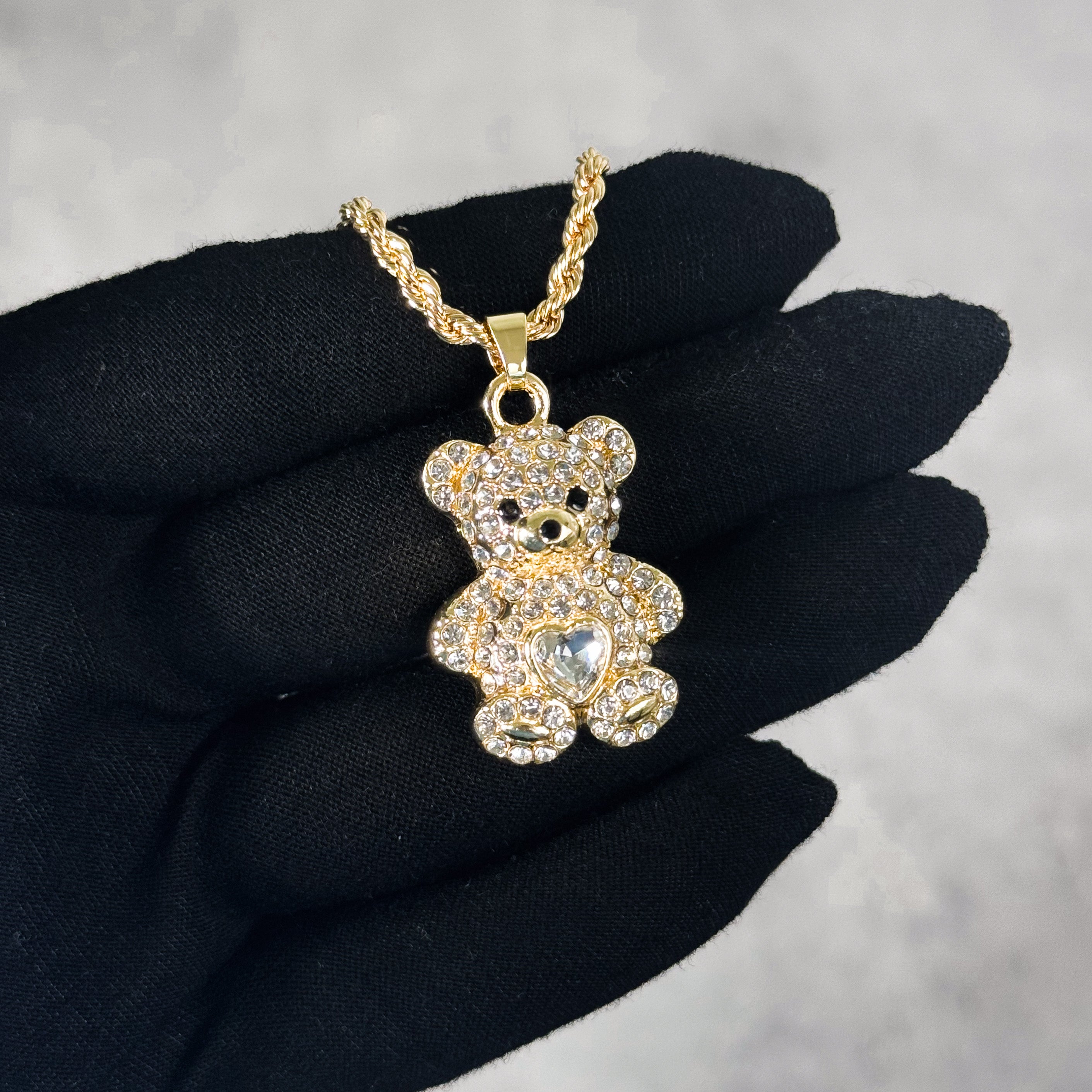 Mini Iced Heart Stone Teddy Pendant gold tone with sparkling stones, shown worn on chain.