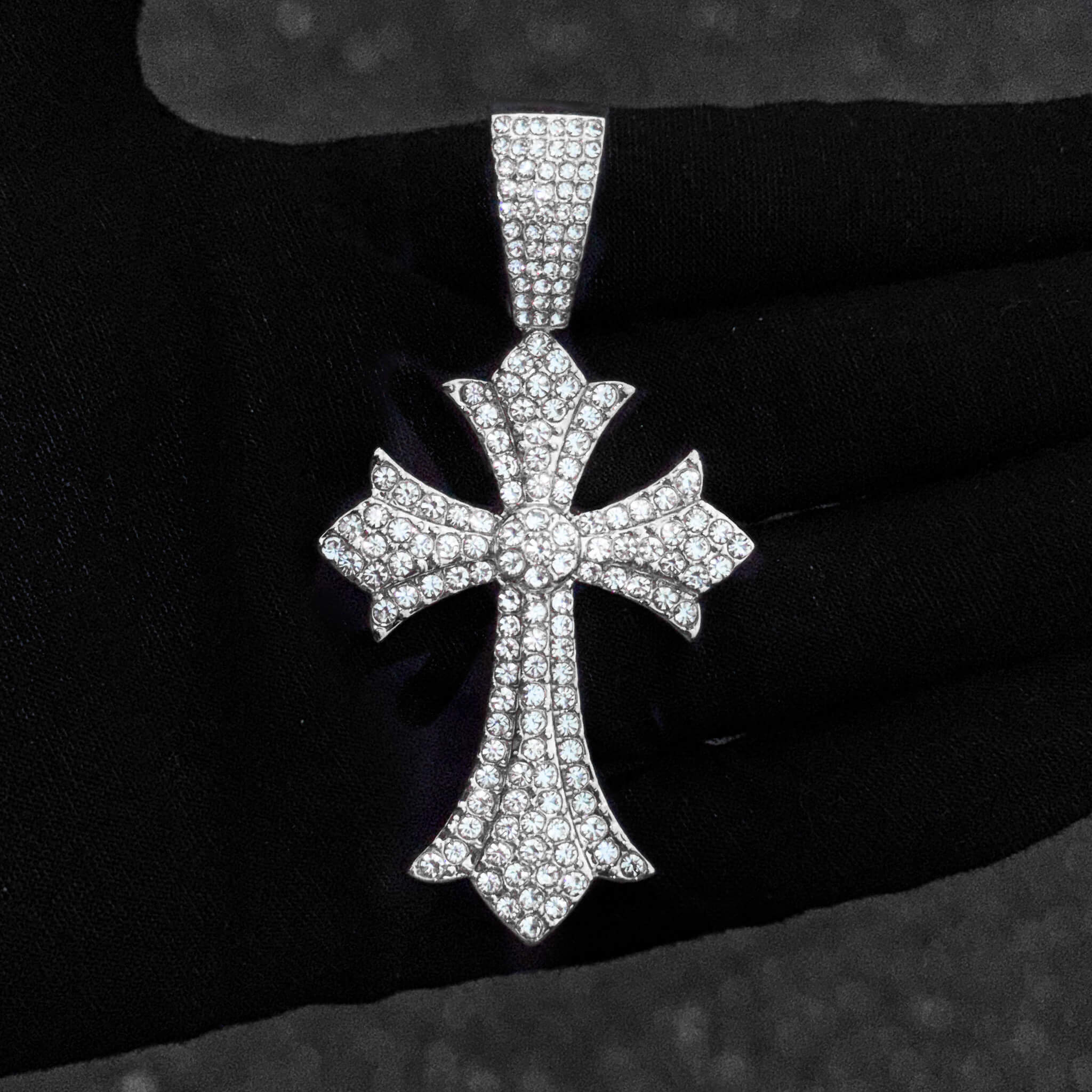 Silver iced-out 40mm men’s cross pendant with pavé clear stones and polished detailed shape.