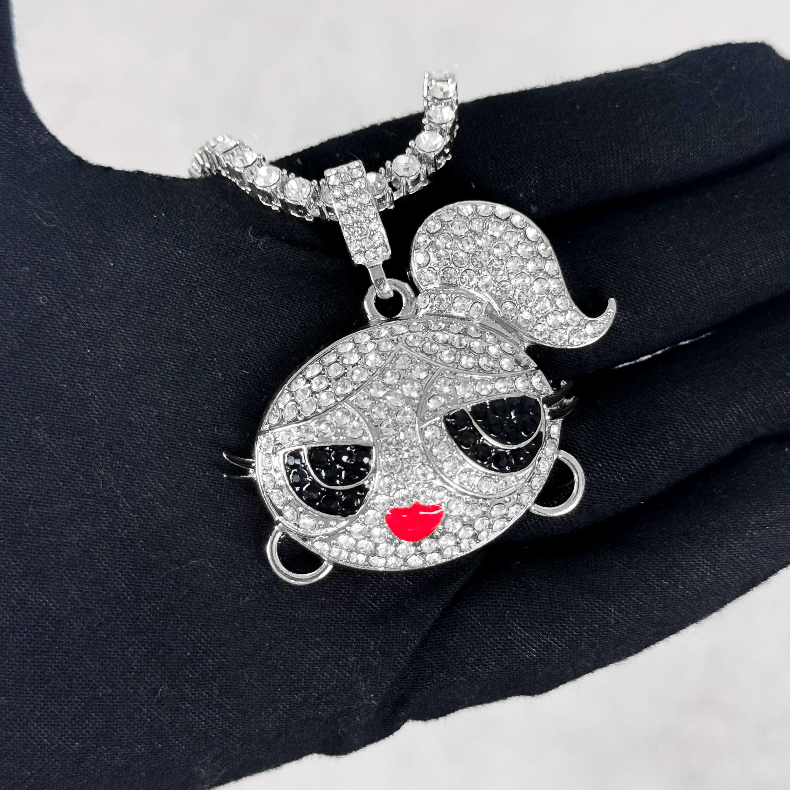 Silver Iced Out Ponytail Doll Pendant with Tennis Chain shown in hand, fully iced CZ design.