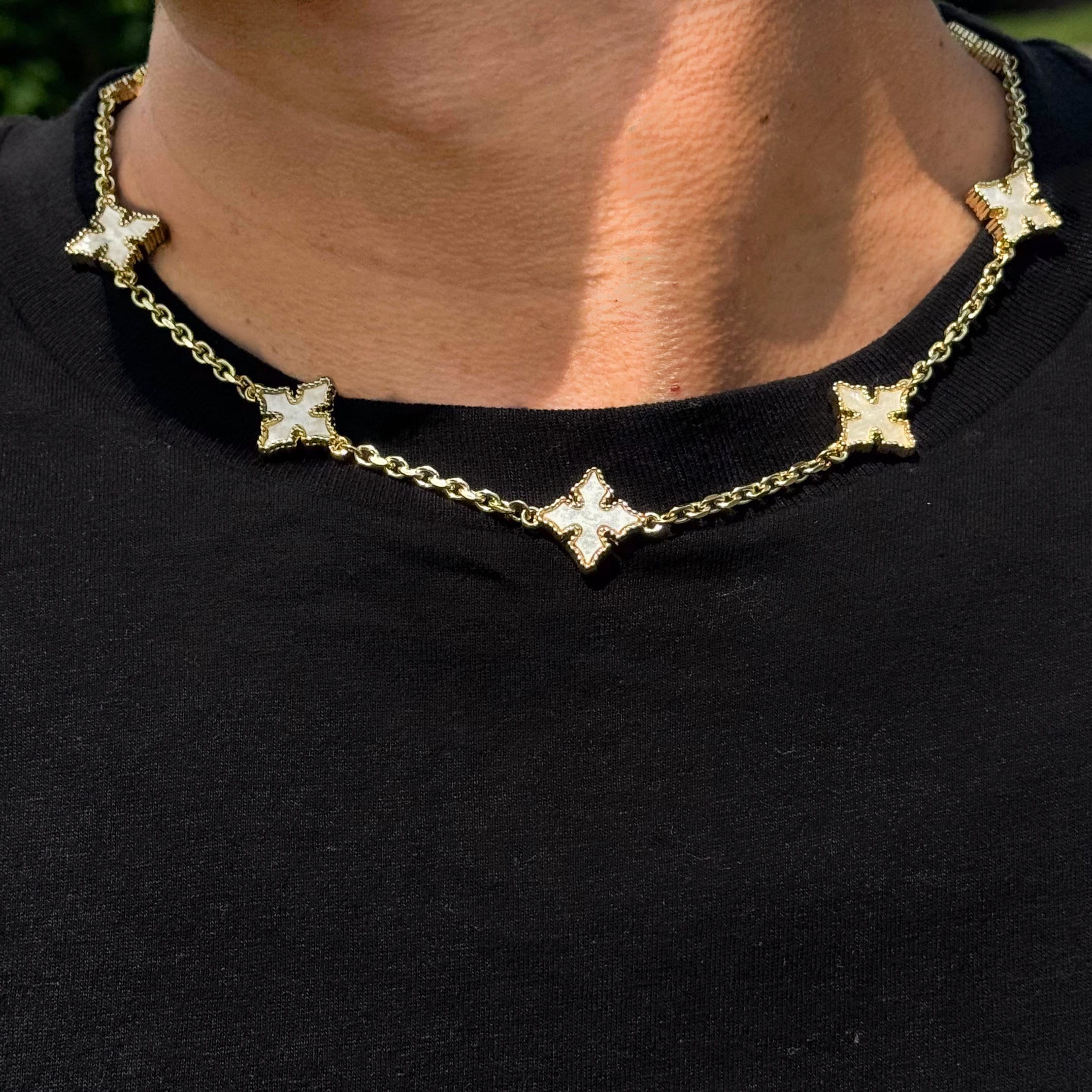 Multi Cross Chrome Inspired Chain - MOP in gold with white mother-of-pearl cross links, worn close-up on neck.