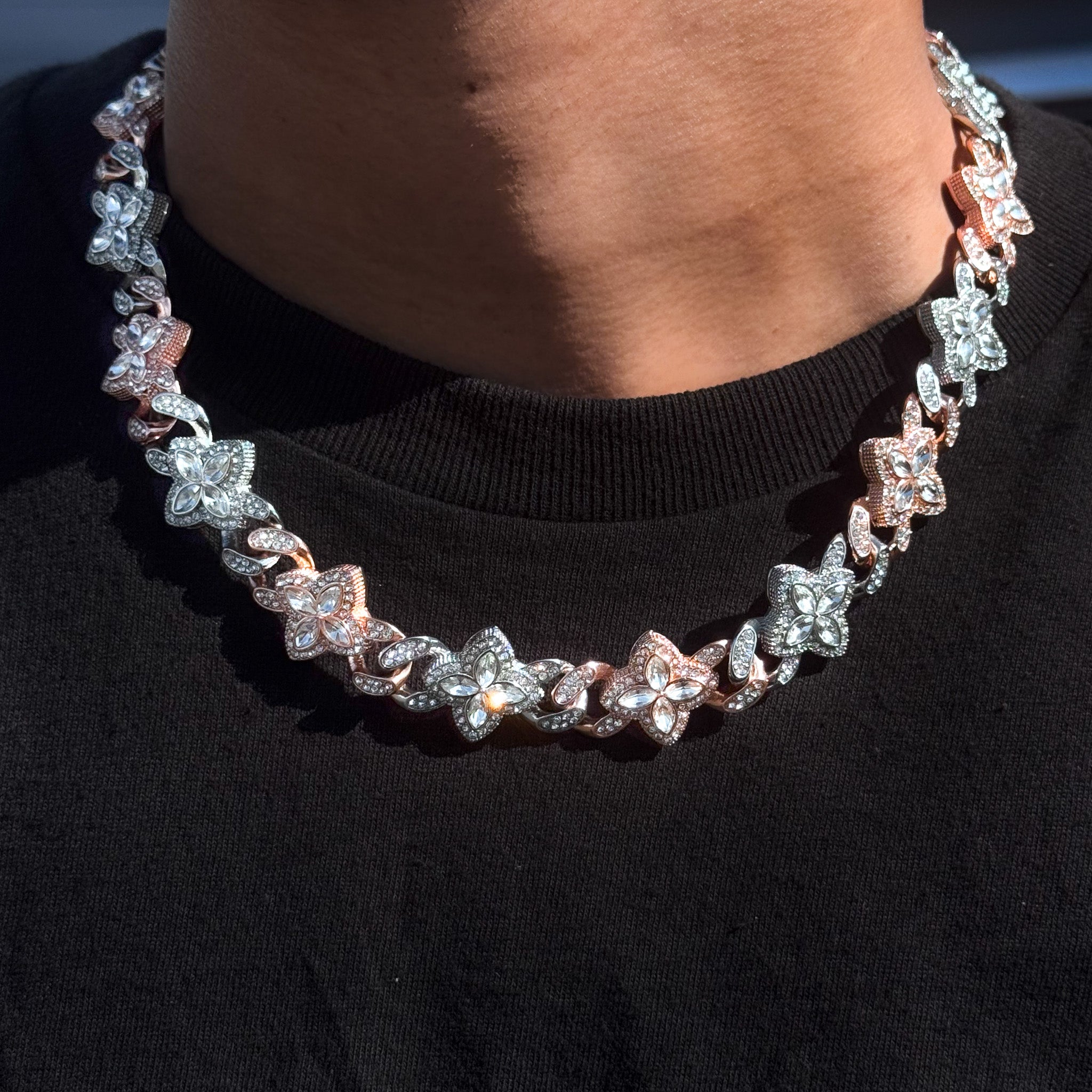 Iced Clover Cuban Chain in rose gold and silver with clear stones, shown worn to highlight shine and detail.