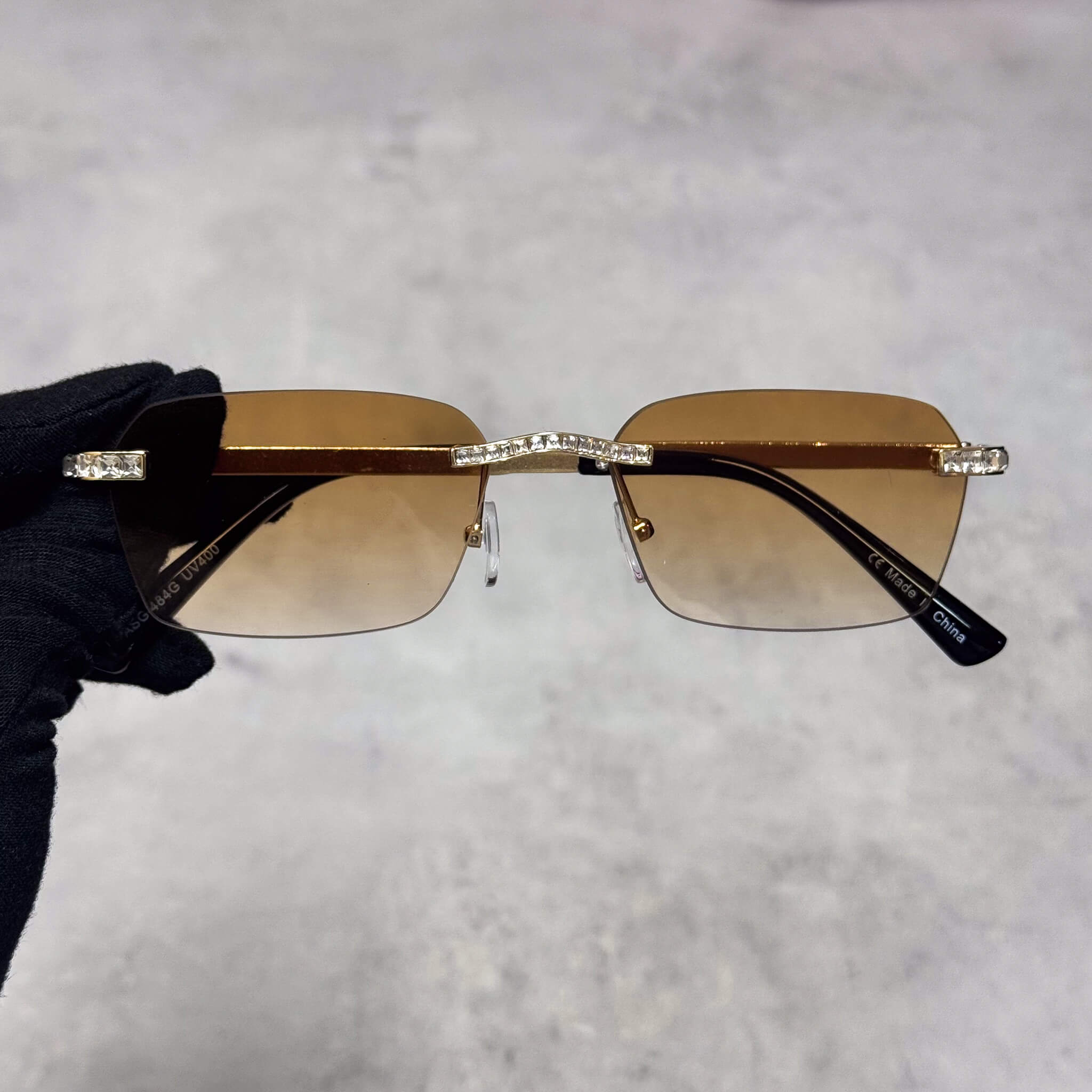 Baguette Stone Sunglasses with brown gradient lenses and gold rimless frame for luxury style.