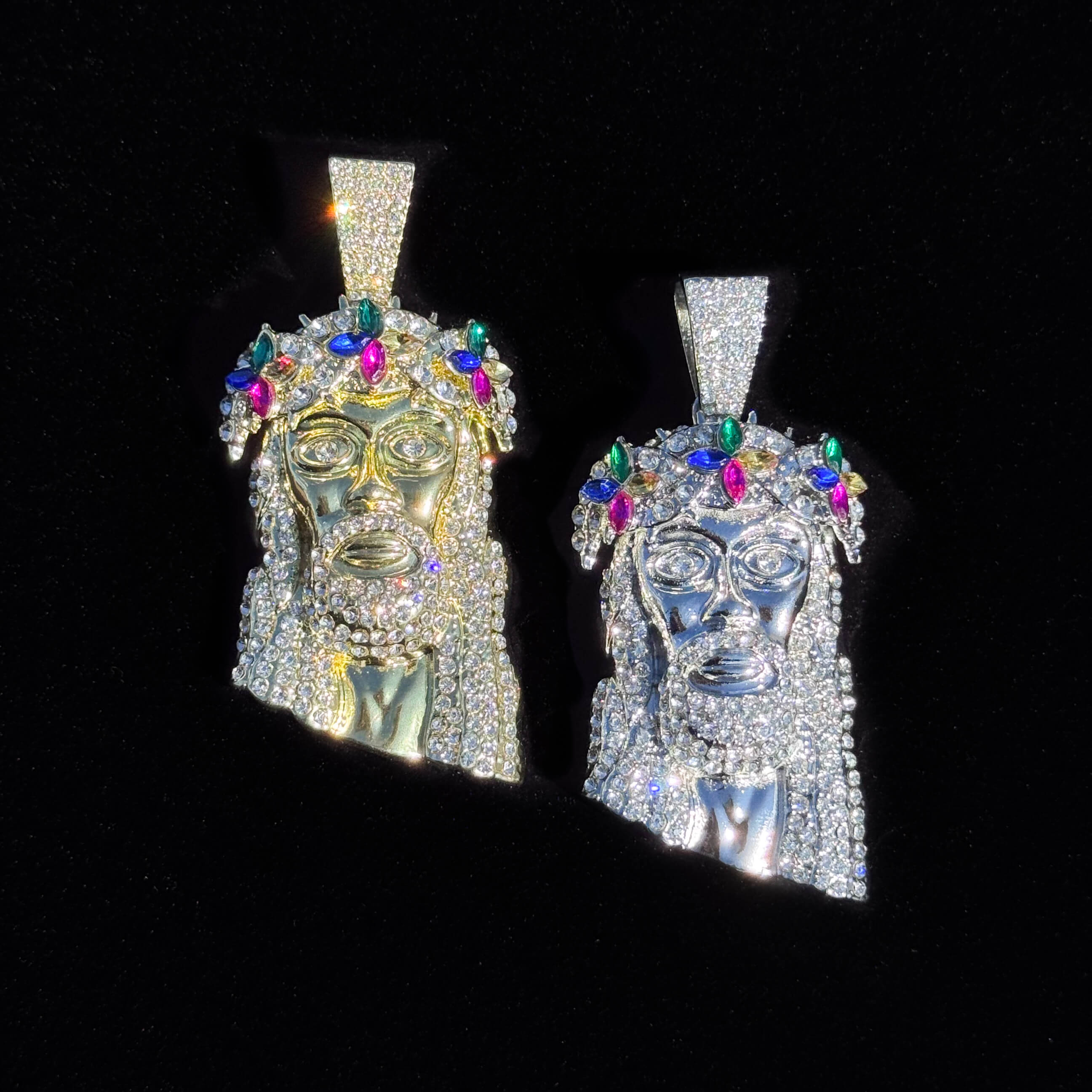 Gold and silver iced-out Jesus floral crown pendants with multicolor gems on black background.