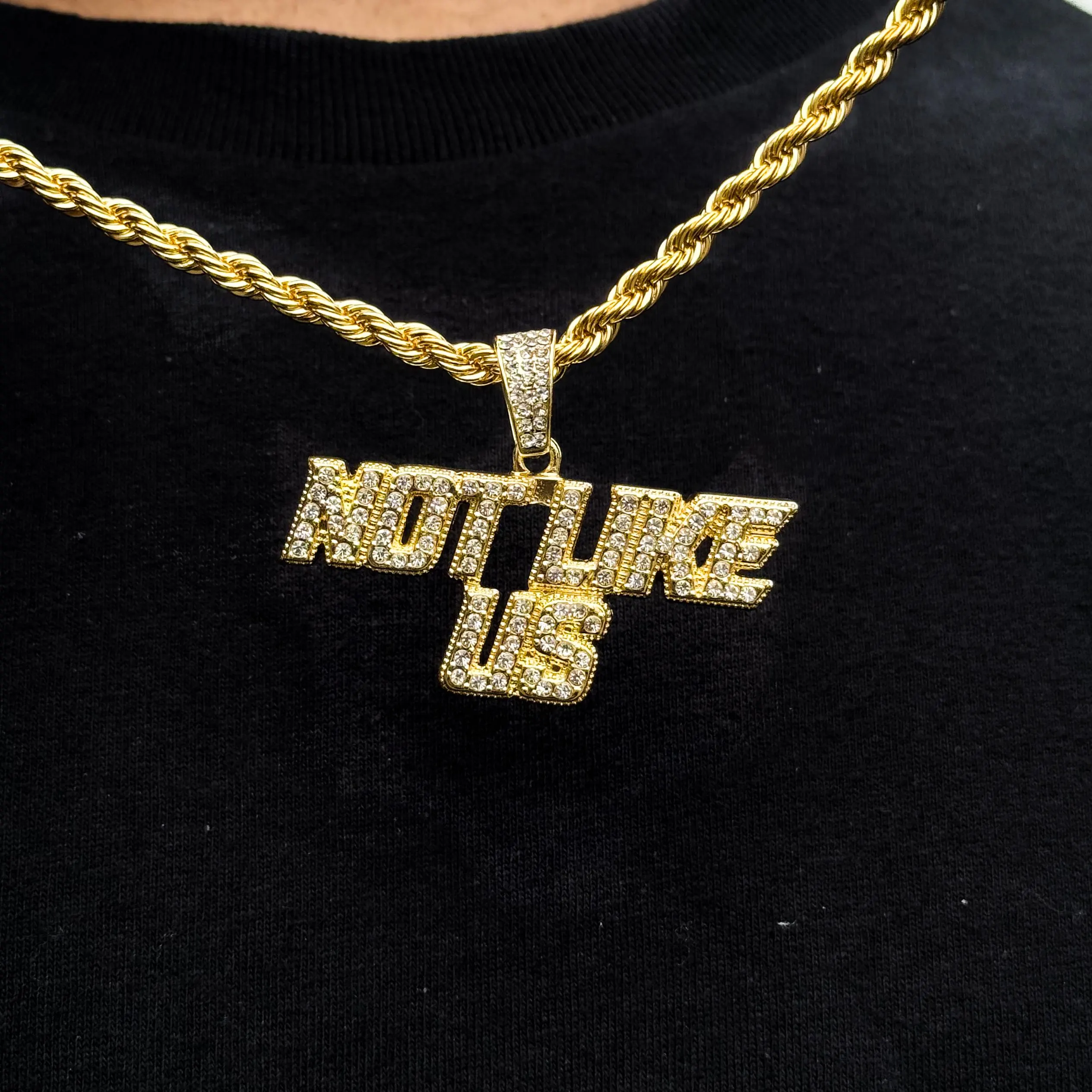 Gold “Not Like Us” iced out pendant on 4mm rope chain for men, hip hop statement jewelry.