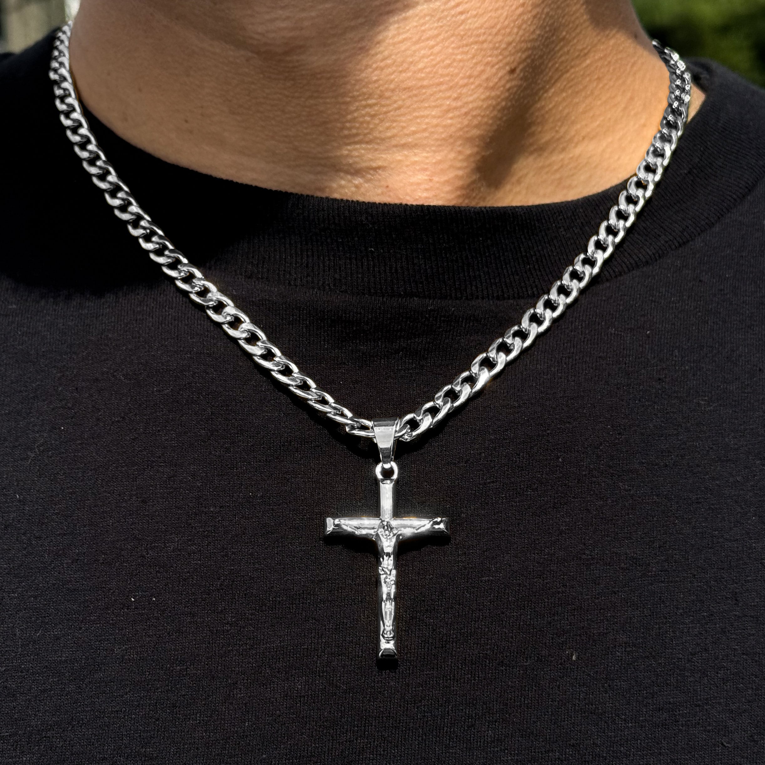 Men's medium silver crucifix pendant on 5mm Cuban chain, polished stainless steel finish.