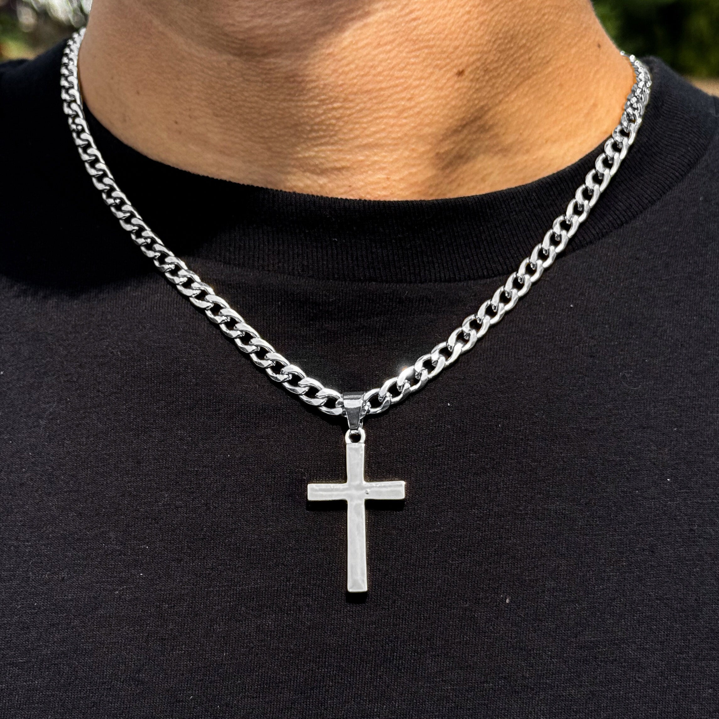 Men's medium silver solid cross pendant on 5mm Cuban chain with polished stainless finish.