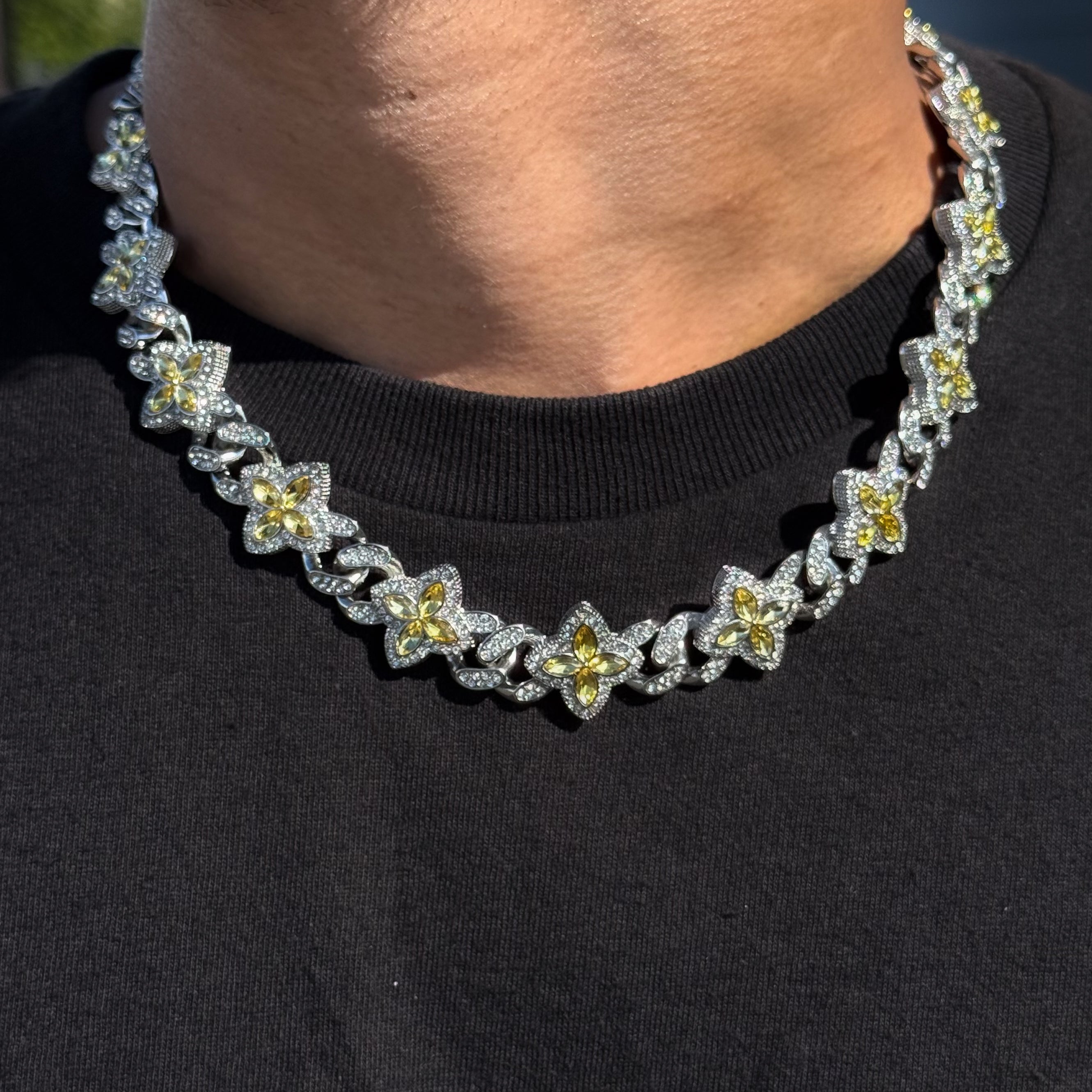 Iced Clover Cuban Chain with yellow stones on a silver finish, shown worn to highlight shine and detail.