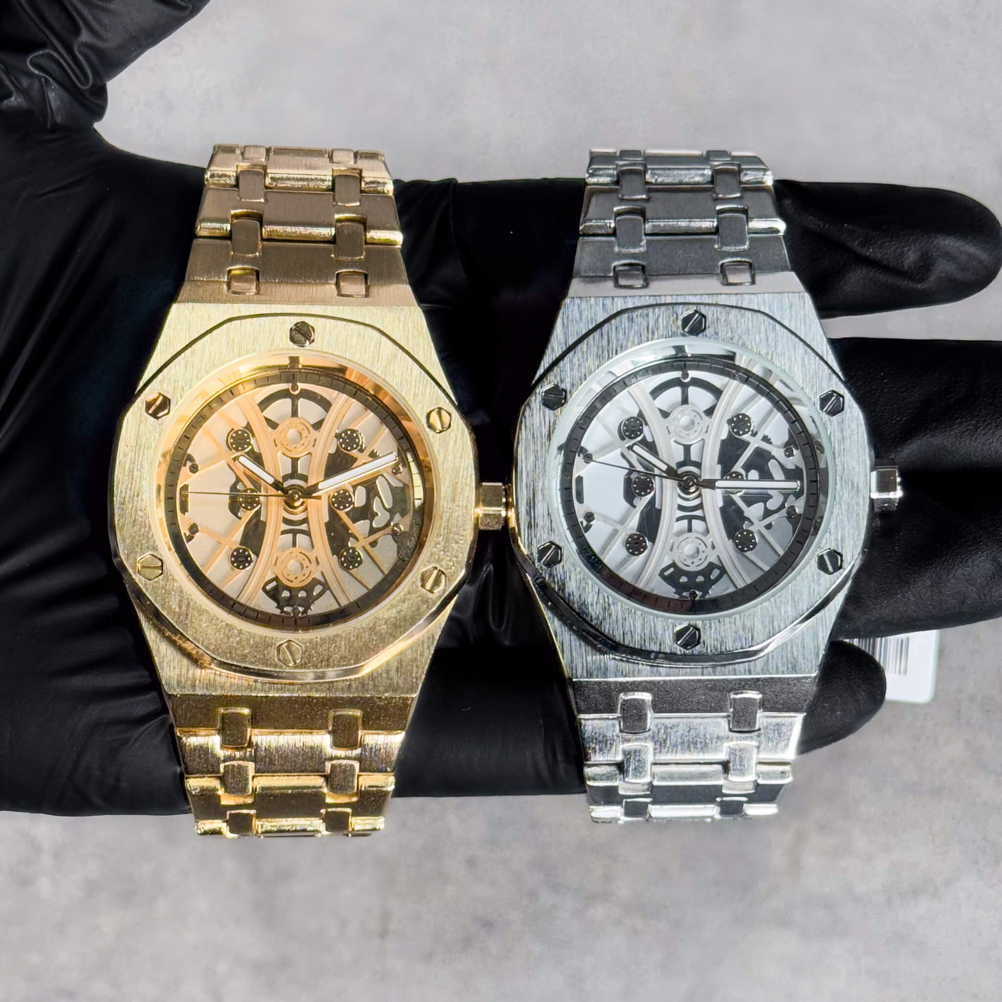 Men’s 40mm luxury skeleton watch in gold and silver, octagon bezel and metal link bands.