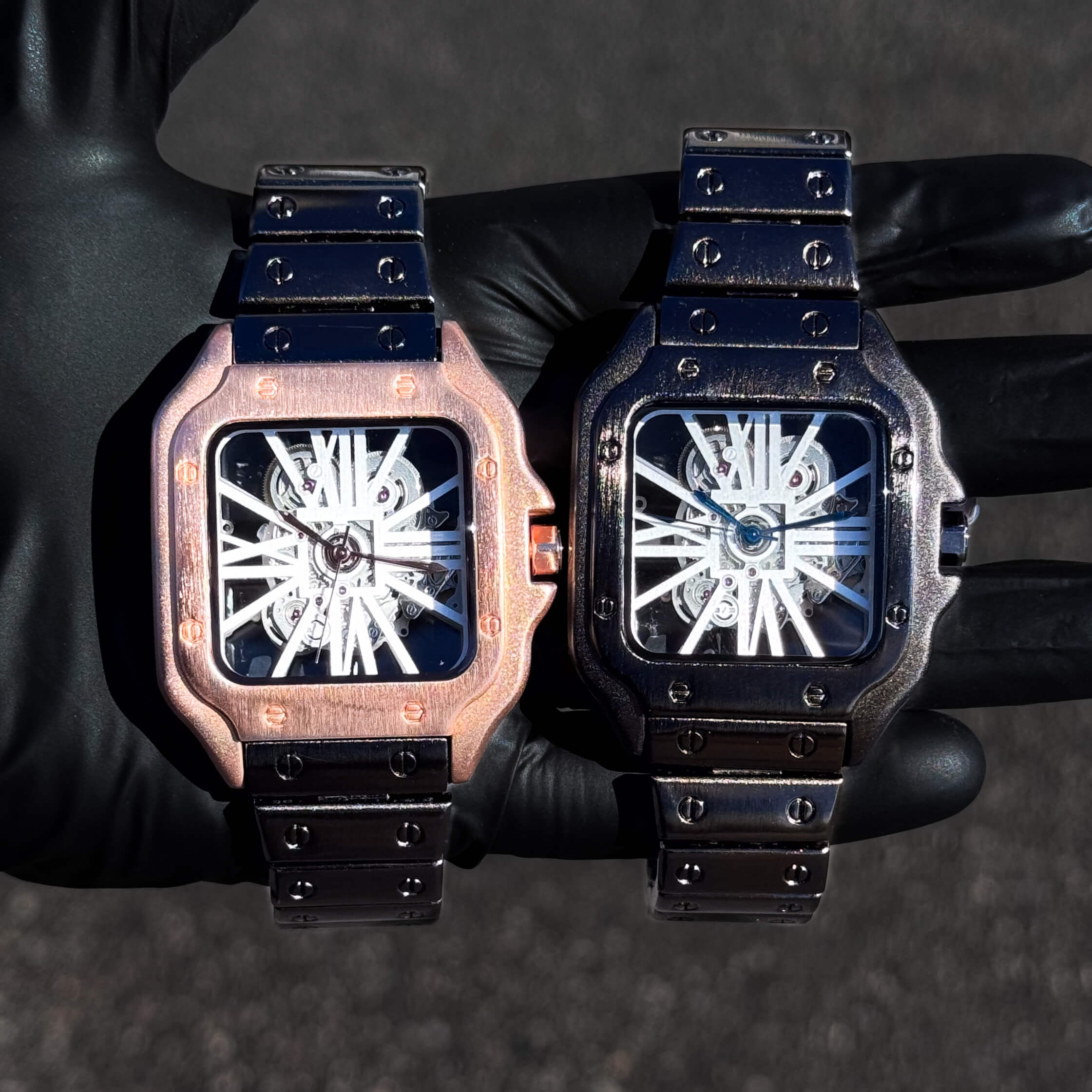 Men's 40mm square skeleton dial watches in rose gold and gunmetal finish with metal bands.