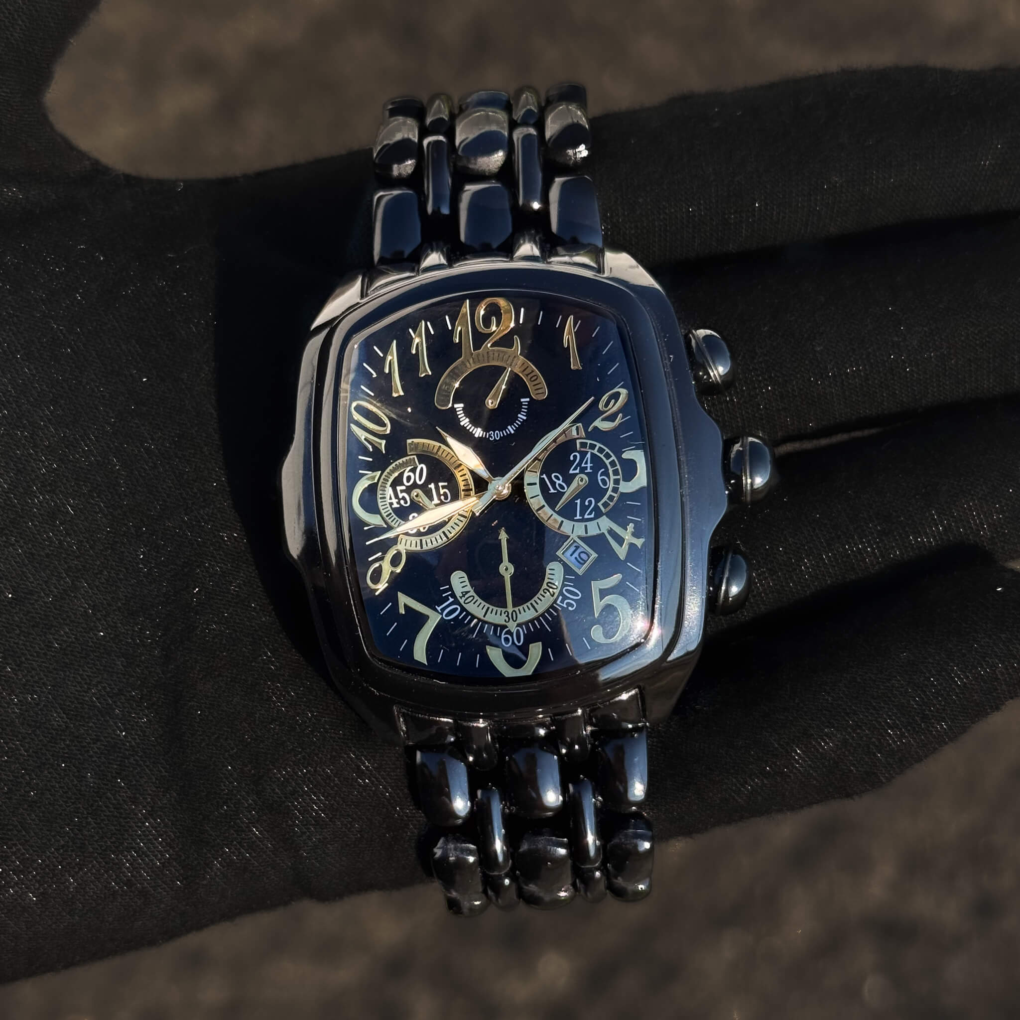 Men’s 43mm Tonneau Watch with black metal band, gold-accent dial and multi-subdial design.