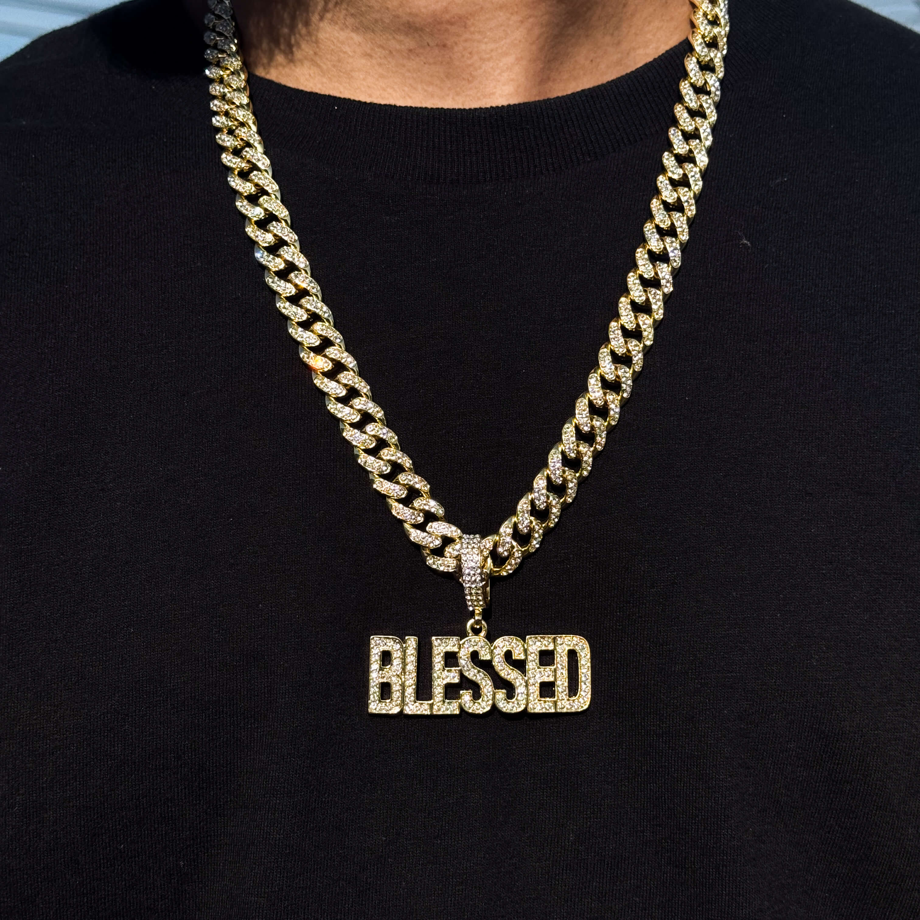 Men's large iced out Blessed pendant on 12mm gold Cuban necklace, sparkling hip hop jewelry.