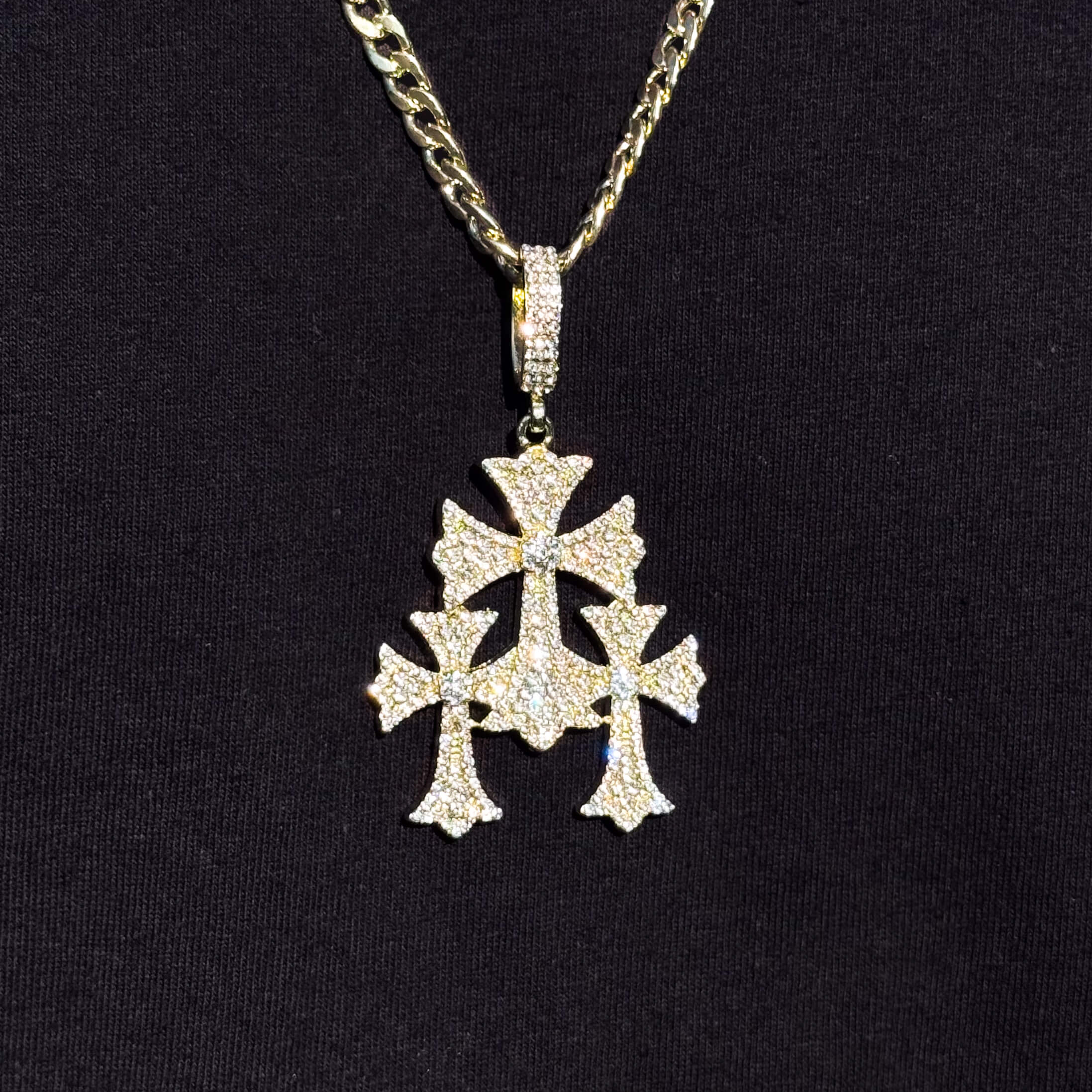 Gold iced out triple cross pendant with Cuban chain for men, featuring sparkling stones.