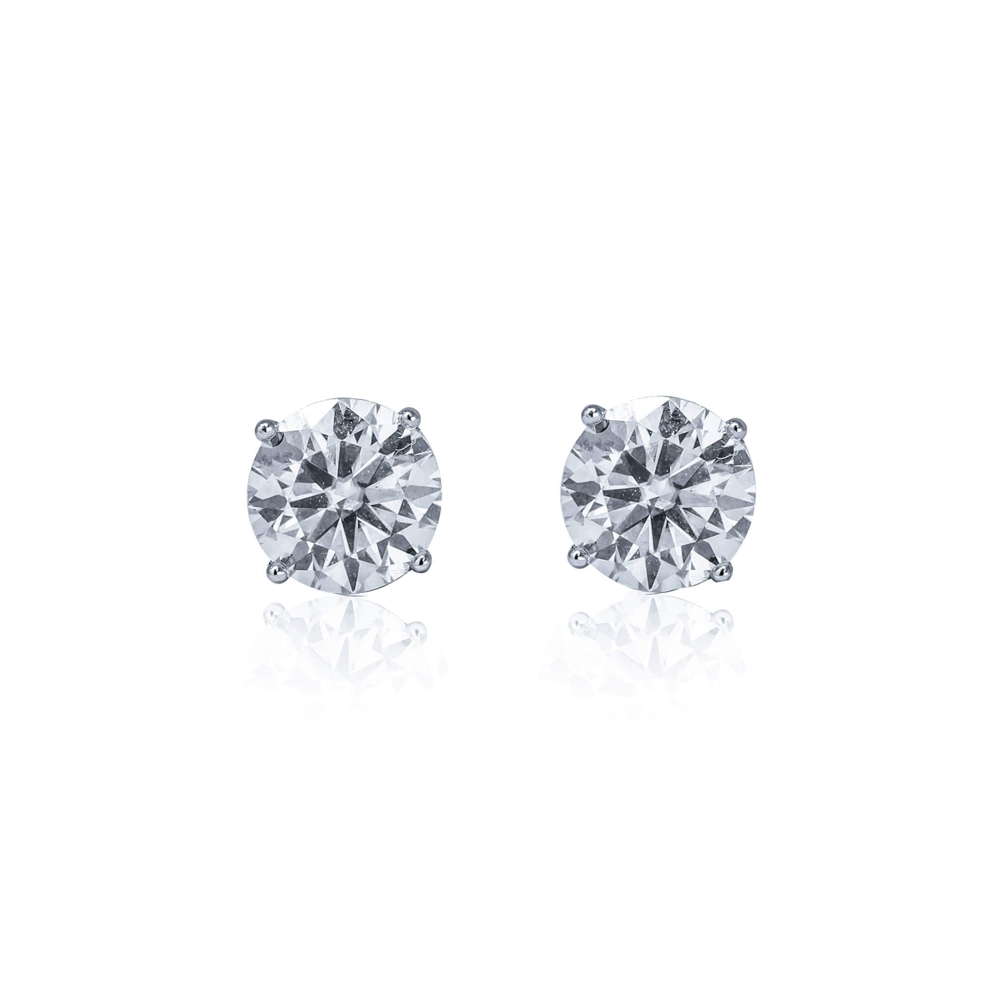 Front view of round moissanite solitaire earrings set in sterling silver four-prong studs.