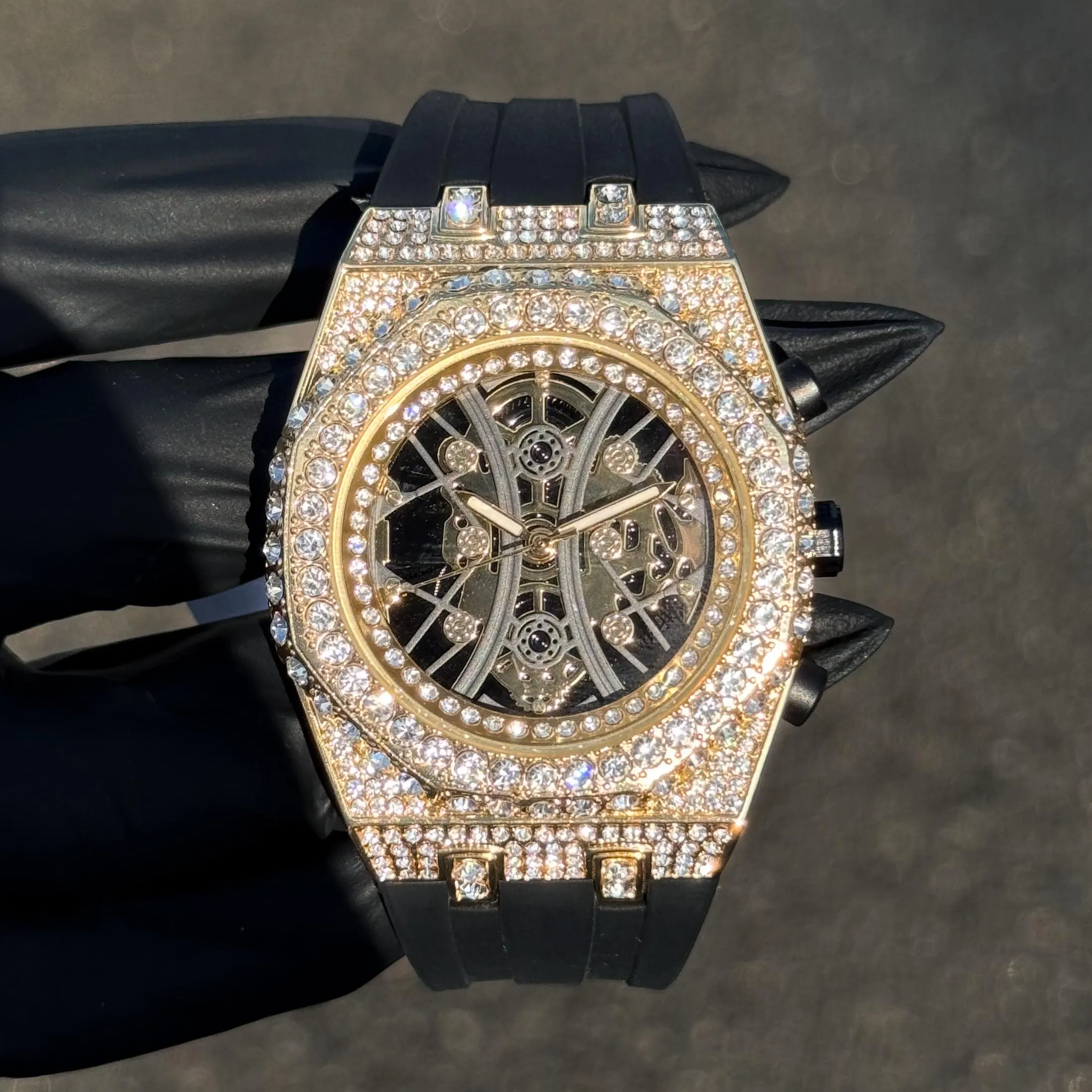 Men's 43mm silicone band diamond watch with gold octagon bezel and skeleton dial.