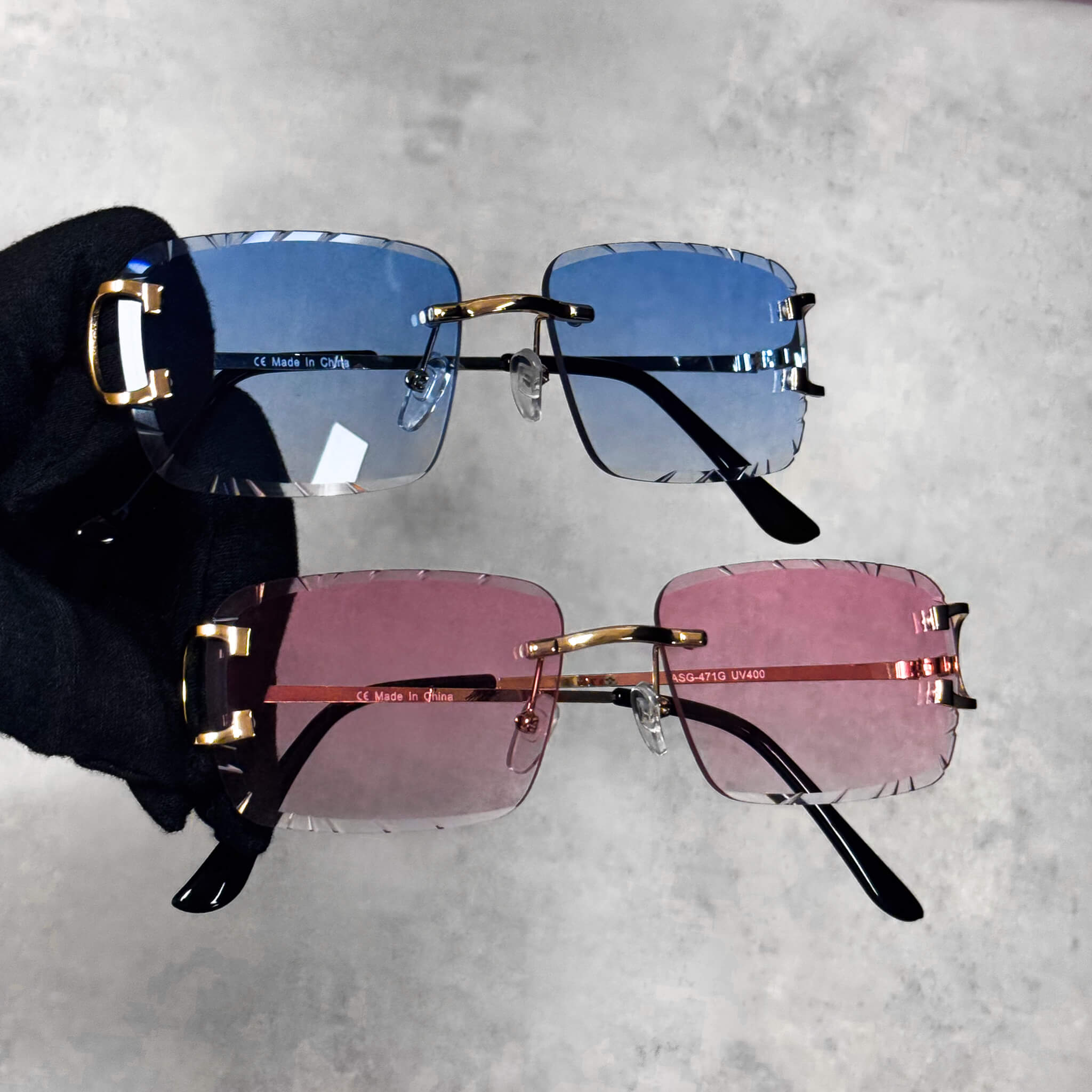 Solid Cut-Edge Sunglasses with blue and pink lenses, gold accents, and rimless square design.