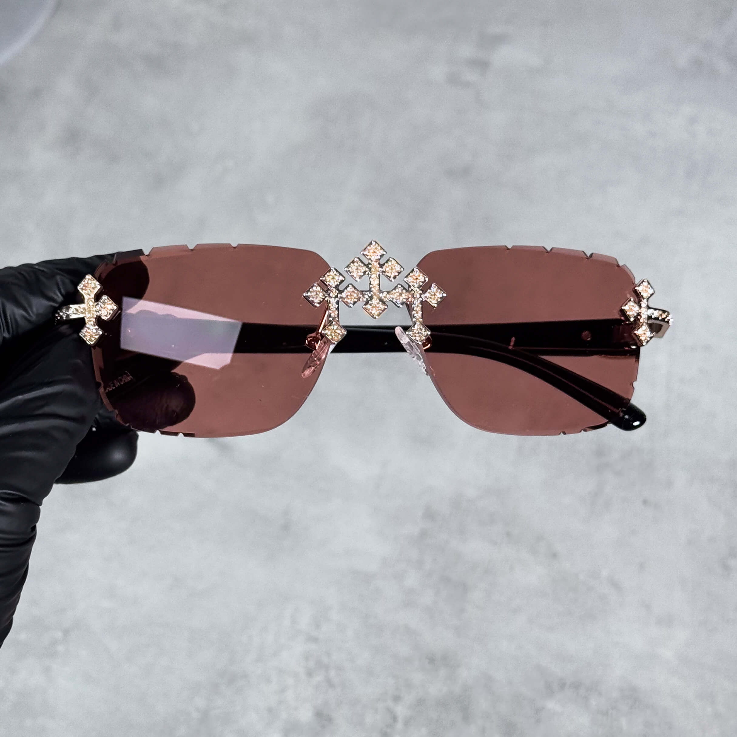 Iced Triple Cross Sunglasses with brown gradient lenses and crystal cross accents on rimless frame.