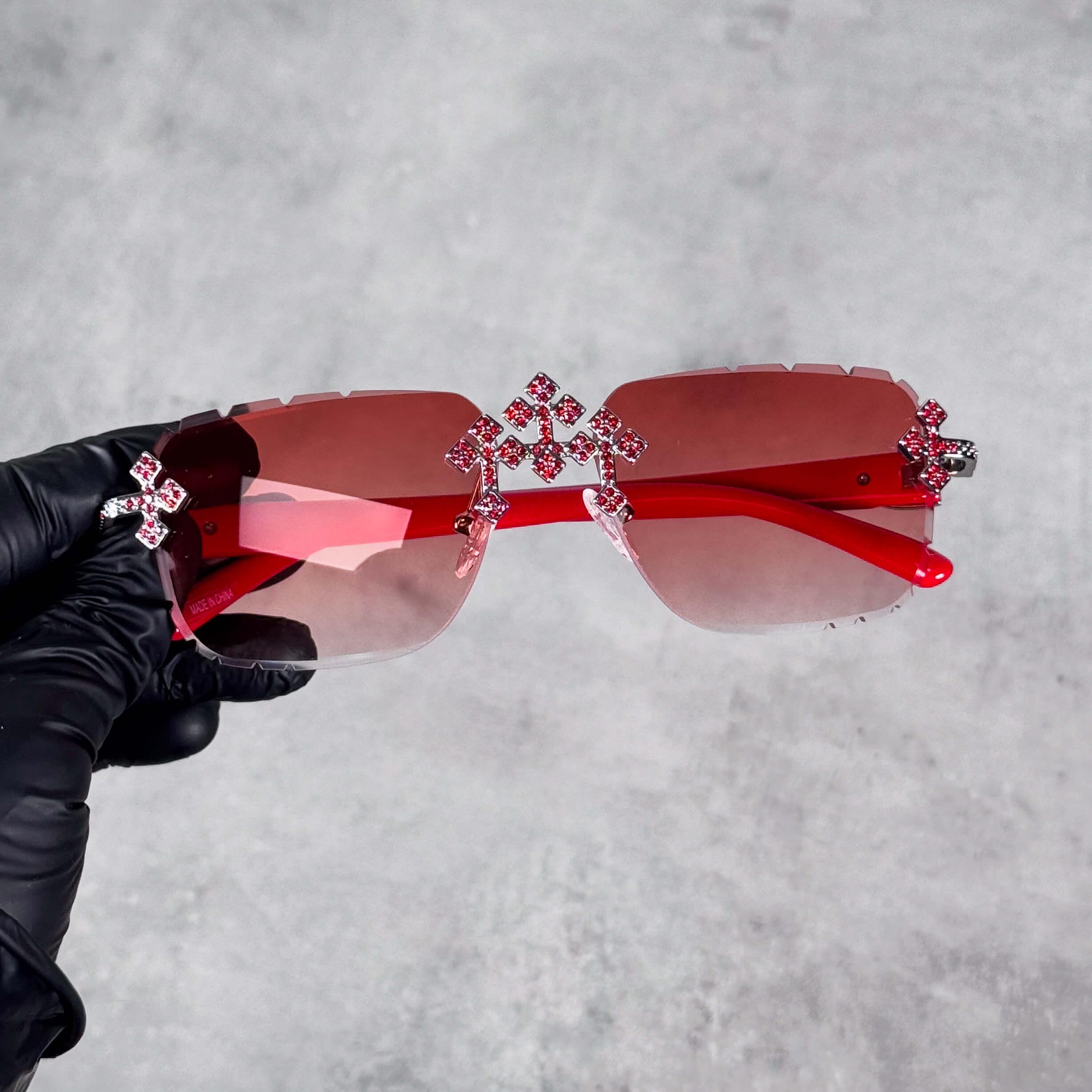 Iced Triple Cross Sunglasses with red gradient lenses and crystal cross accents on rimless frame.