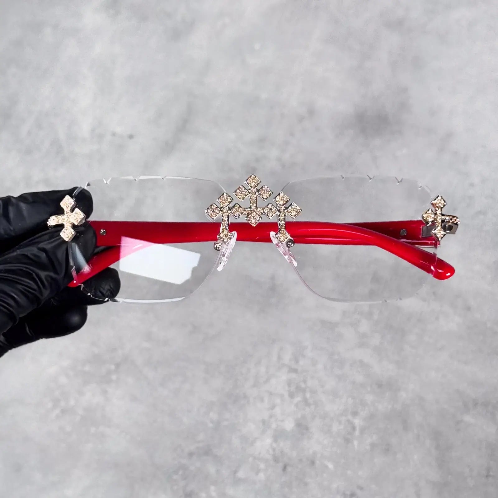 Iced Triple Cross Sunglasses with clear lenses and red arms featuring crystal cross accents.