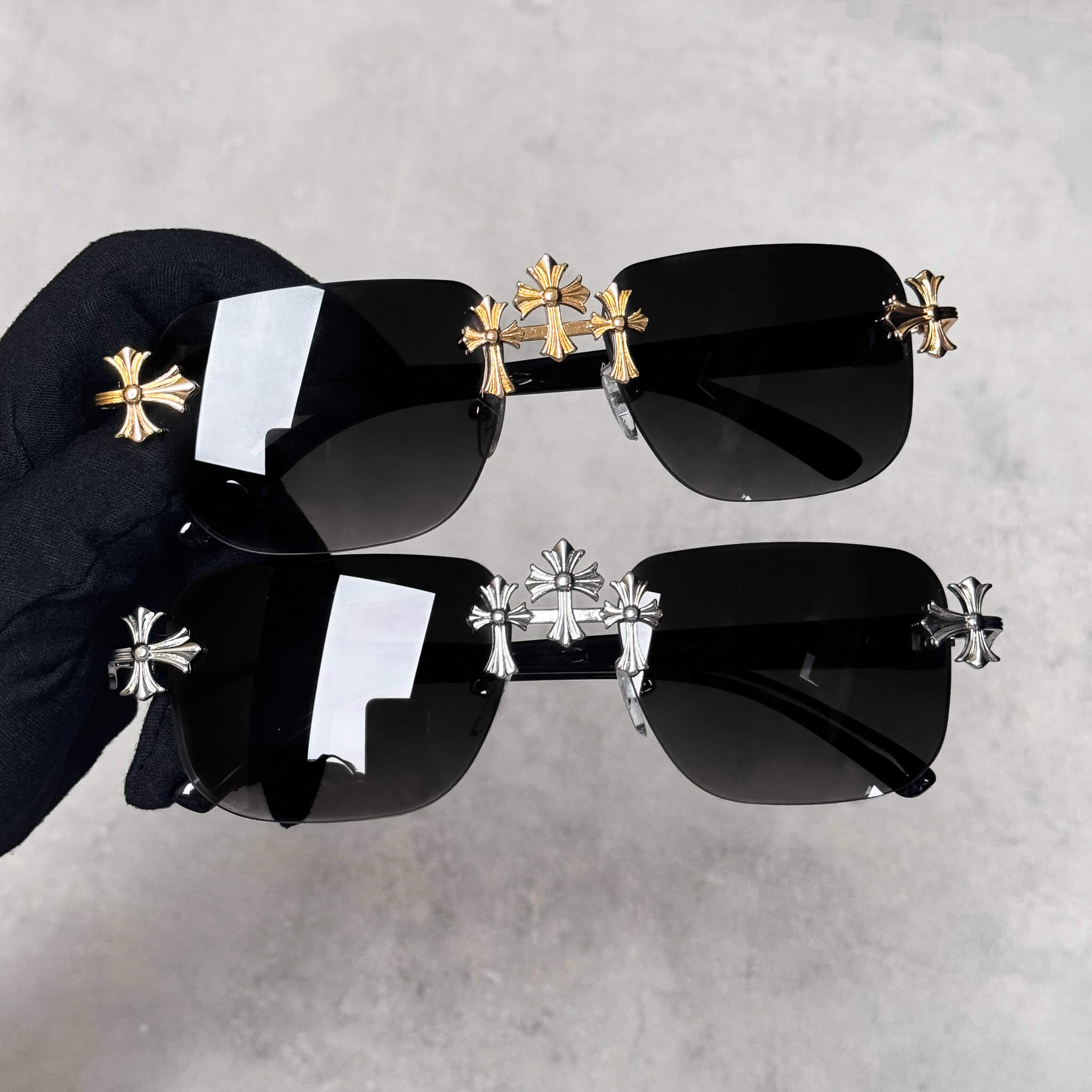 Solid Triple Cross Sunglasses with black lenses and gold cross hardware in a bold square frame.